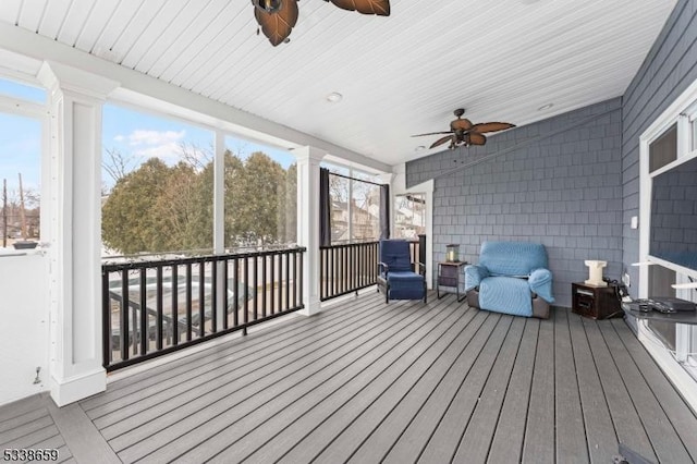 sunroom / solarium featuring ceiling fan