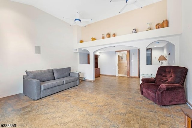 living room with a baseboard heating unit, high vaulted ceiling, and ceiling fan