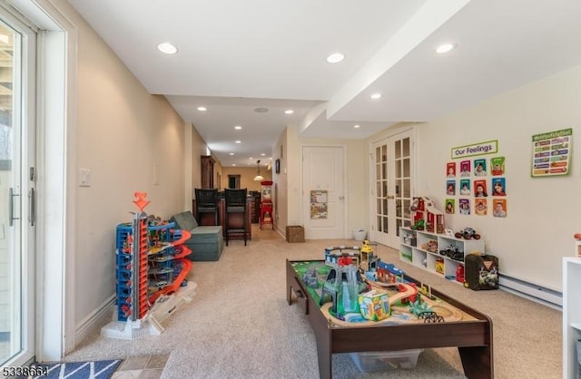 recreation room with light colored carpet, a baseboard heating unit, recessed lighting, baseboards, and french doors