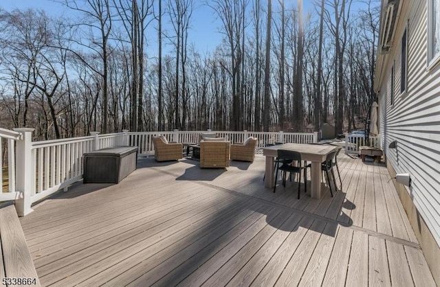 wooden terrace featuring outdoor dining space and an outdoor living space