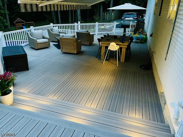 deck with outdoor dining space and outdoor lounge area