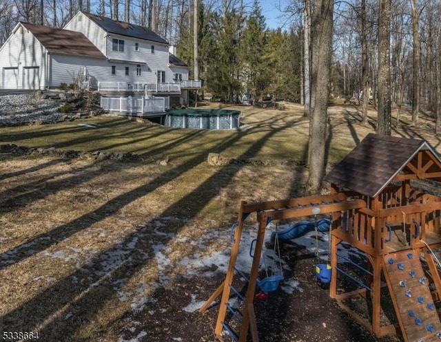 view of yard with a playground and a covered pool