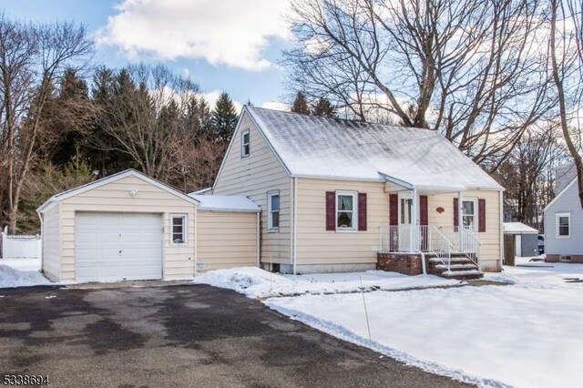 view of front of property with a garage and an outbuilding