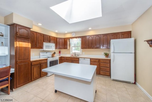 345 Center Grove Rd, Randolph Twp, NJ 07869 - kitchen featuring a center island, sink, white appliances, light tile patterned floors, and a skylight
