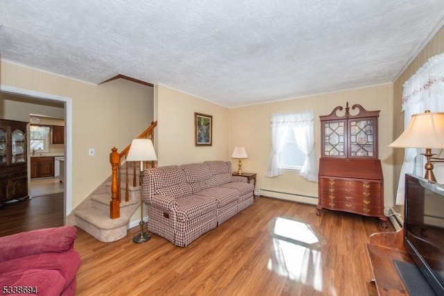 345 Center Grove Rd, Randolph Twp, NJ 07869 - living room featuring baseboard heating, a textured ceiling, hardwood / wood-style flooring, and sink