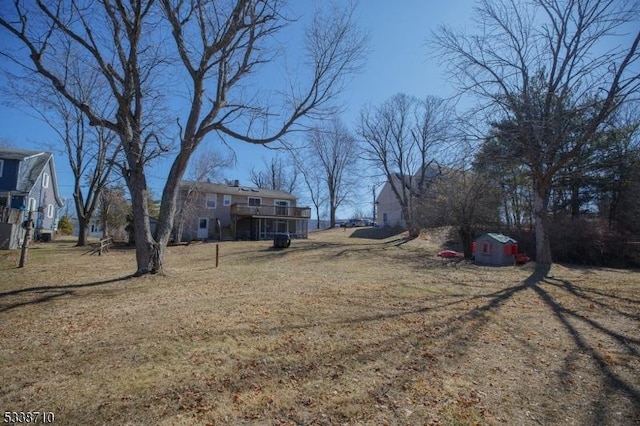 view of yard with a storage unit and an outbuilding