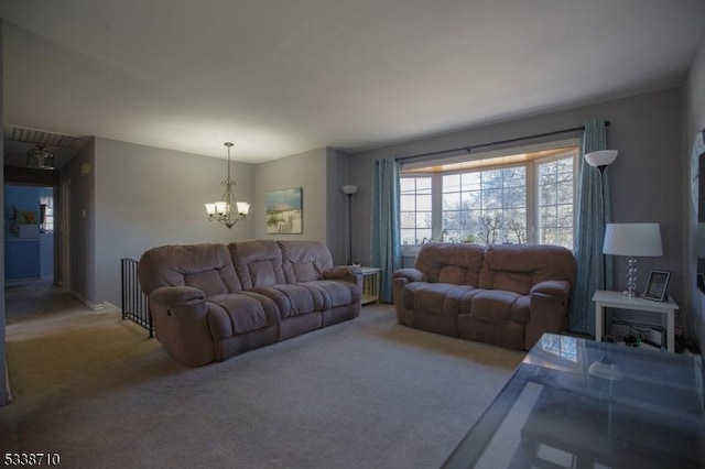 living area with a notable chandelier and carpet