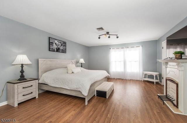 bedroom with hardwood / wood-style flooring