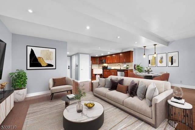 living room with beam ceiling and hardwood / wood-style flooring