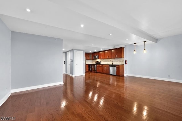 unfurnished living room featuring dark hardwood / wood-style flooring and indoor wet bar