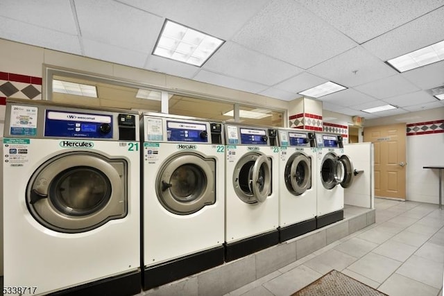 laundry room featuring light tile patterned floors and washer and clothes dryer