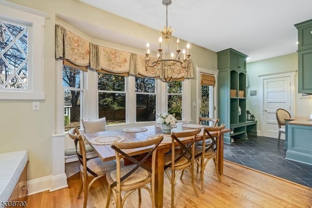 dining space featuring dark wood-type flooring and a notable chandelier