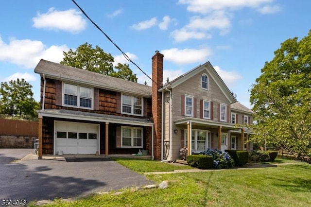 view of front facade featuring a garage and a front lawn