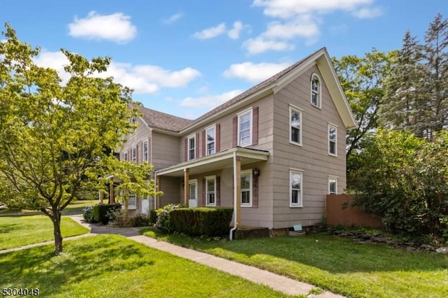 view of front of property with a front yard and a porch