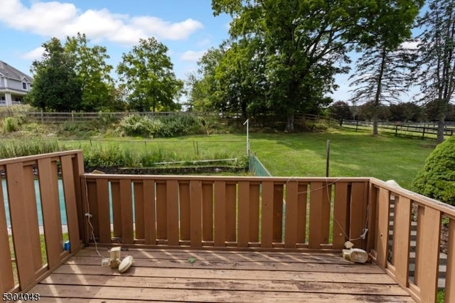 wooden terrace featuring a yard