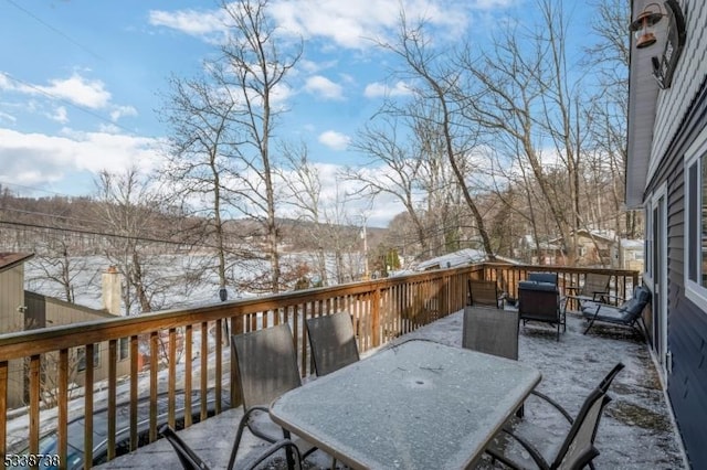 snow covered deck featuring outdoor dining area