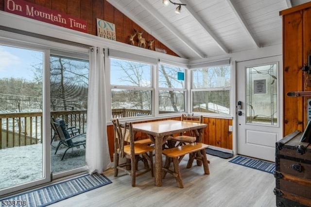 sunroom featuring lofted ceiling with beams, wooden ceiling, and rail lighting