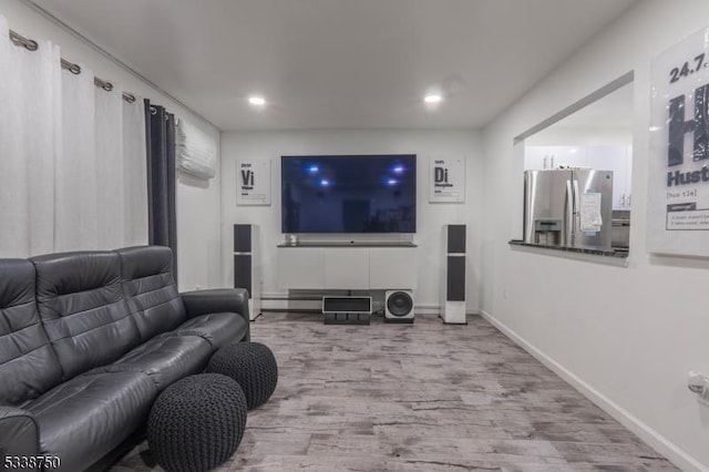 living room with recessed lighting, baseboards, and wood finished floors