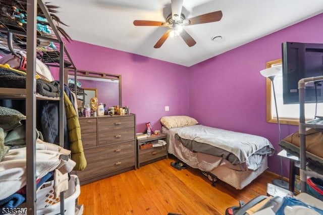 bedroom featuring hardwood / wood-style floors and ceiling fan