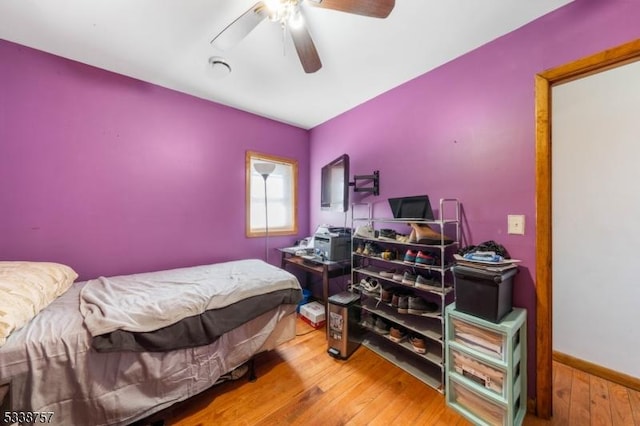 bedroom with hardwood / wood-style floors and ceiling fan