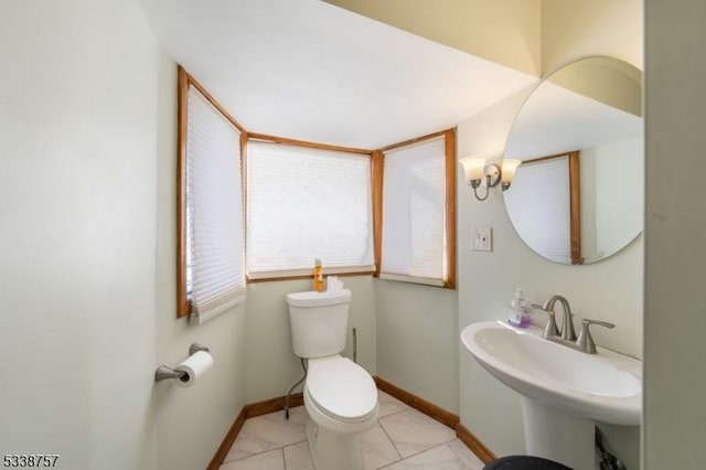 bathroom featuring sink, tile patterned floors, and toilet