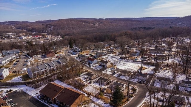 snowy aerial view with a mountain view