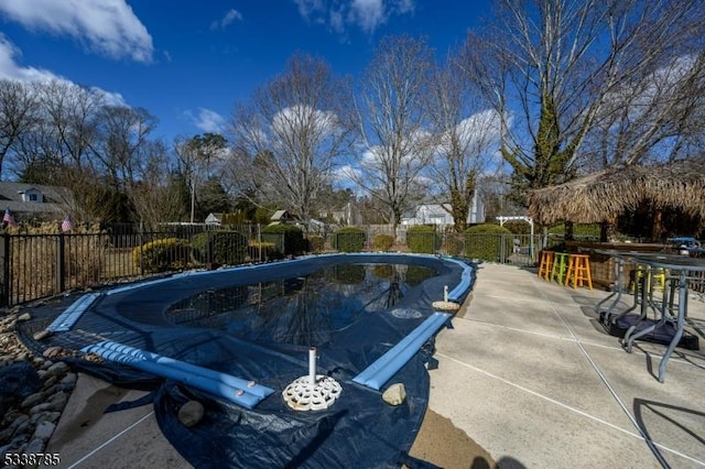 view of pool featuring an outdoor bar and a patio area