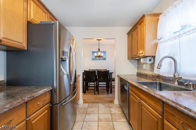 kitchen featuring sink, black dishwasher, a notable chandelier, stainless steel fridge with ice dispenser, and decorative backsplash