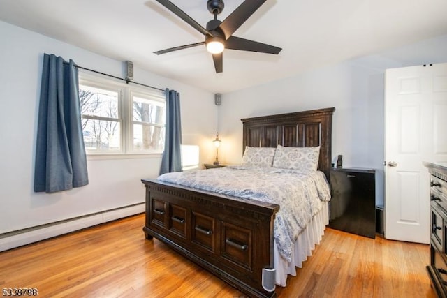 bedroom featuring a baseboard radiator, ceiling fan, and light hardwood / wood-style floors