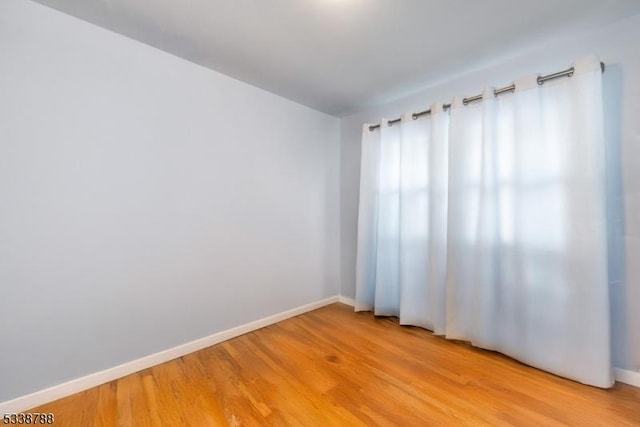 spare room featuring light hardwood / wood-style flooring