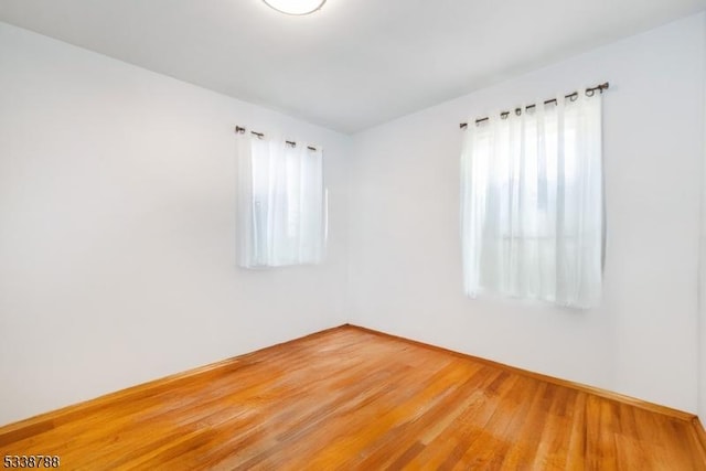 spare room with hardwood / wood-style flooring