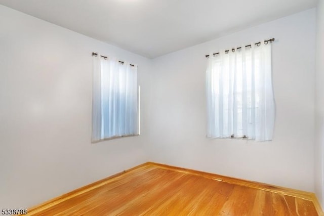 spare room featuring hardwood / wood-style floors