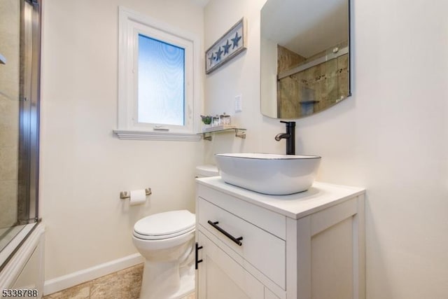 full bathroom featuring toilet, vanity, tile patterned flooring, and enclosed tub / shower combo