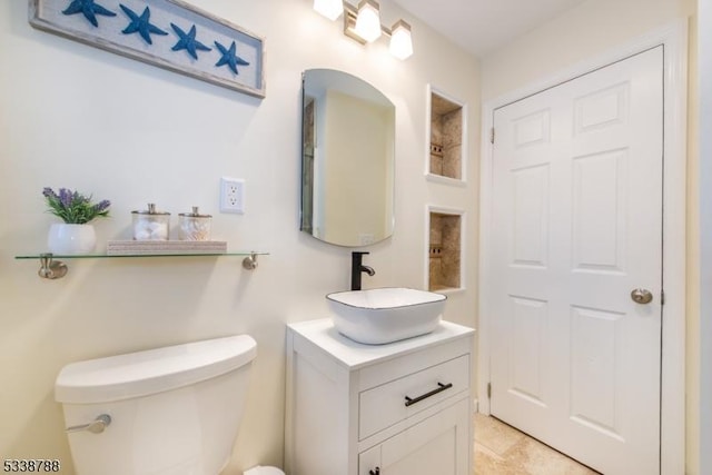 bathroom featuring toilet and vanity