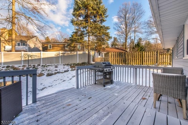 snow covered deck featuring area for grilling