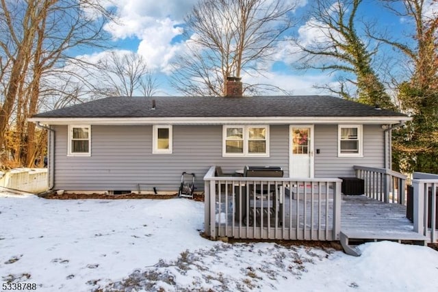 snow covered property with a wooden deck