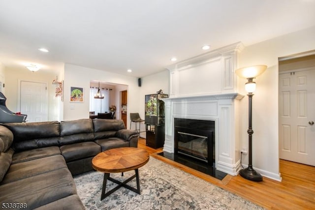 living room with hardwood / wood-style flooring and an inviting chandelier