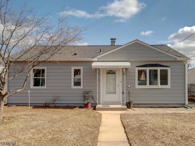 bungalow-style home with a front lawn