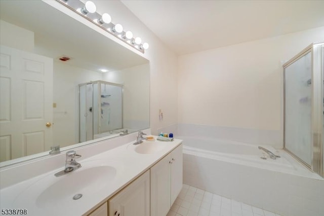 full bathroom with tile patterned floors, double vanity, a sink, and a bath