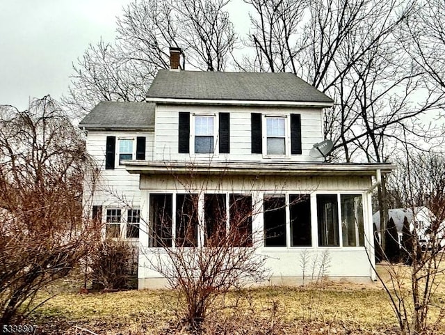 back of house with a sunroom