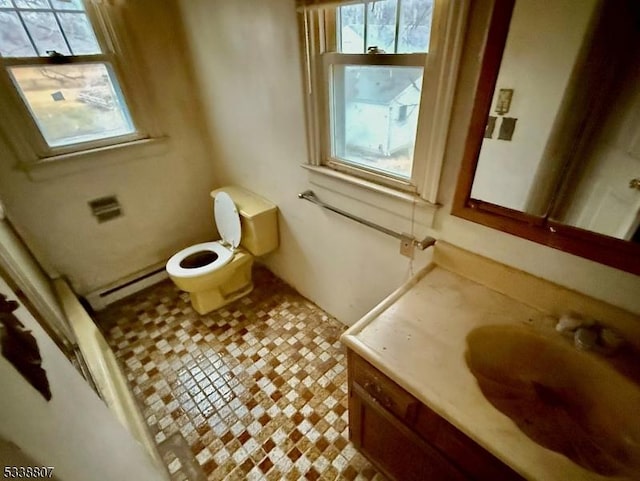 bathroom with a baseboard heating unit, toilet, and vanity