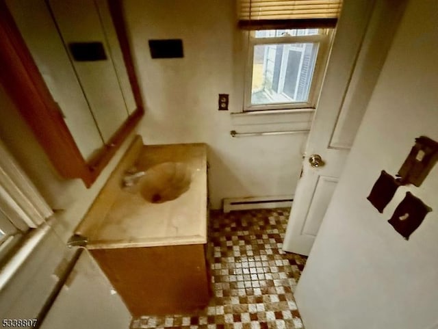 bathroom with baseboard heating and vanity