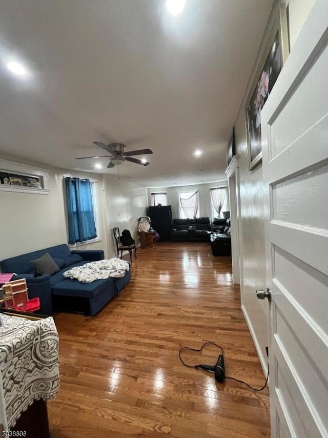 living room featuring hardwood / wood-style floors and ceiling fan