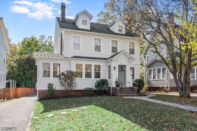 view of front facade with a front yard and fence