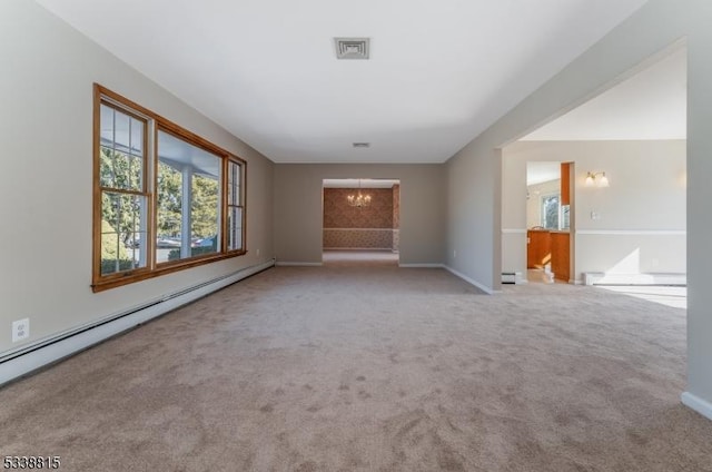 unfurnished living room featuring light colored carpet, a notable chandelier, visible vents, and baseboard heating