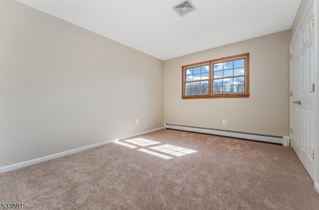 spare room featuring a baseboard radiator, light carpet, visible vents, and baseboards