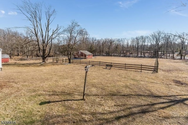 view of yard featuring a rural view and fence