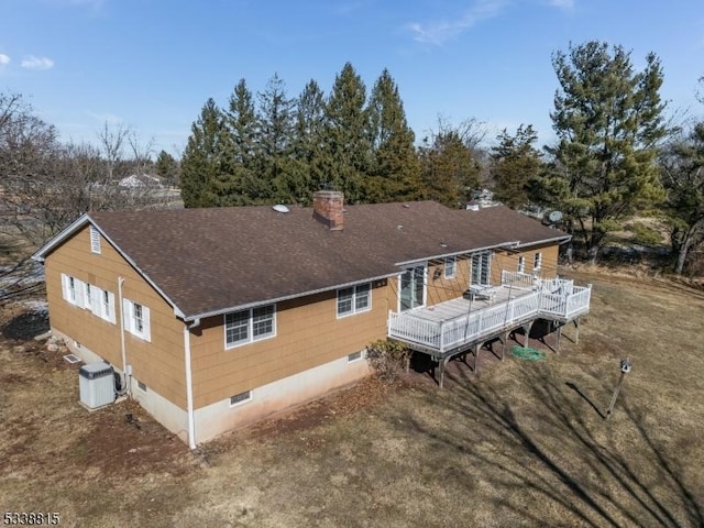 back of house with a chimney, a shingled roof, crawl space, central AC, and a wooden deck