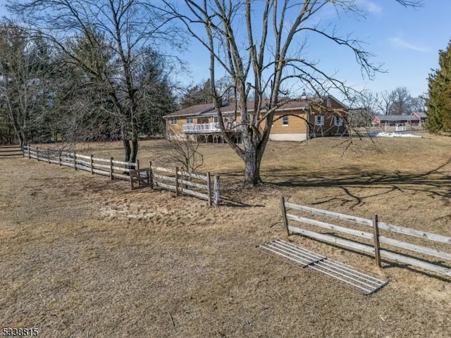 view of yard featuring fence and a rural view