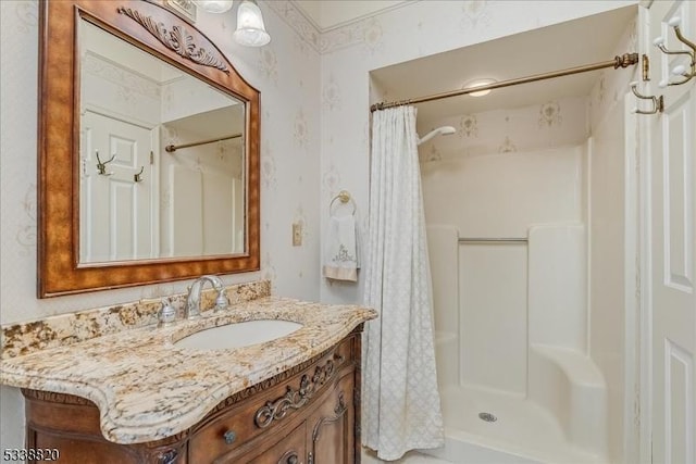 full bath featuring vanity and a shower with shower curtain